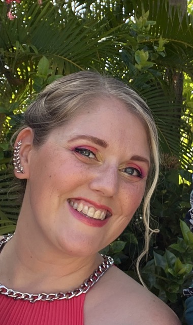 Becky Ferrel smiling at an outdoor wedding in the Dominican Republic. 